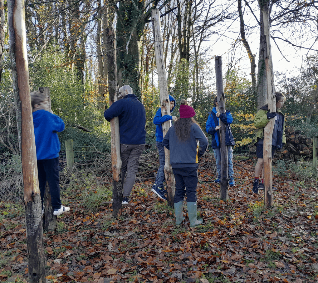 Learners from The Stable School working together on low-ropes challenges at Magdalen Farm in Christchurch, Dorset.