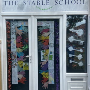 Colourful handprints, decorated keys and positive messages come together to showcase inclusion and belonging at The Stable School's EDI installation.