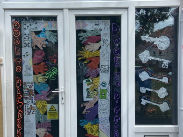Colourful handprints, decorated keys and positive messages come together to showcase inclusion and belonging at The Stable School's EDI installation.