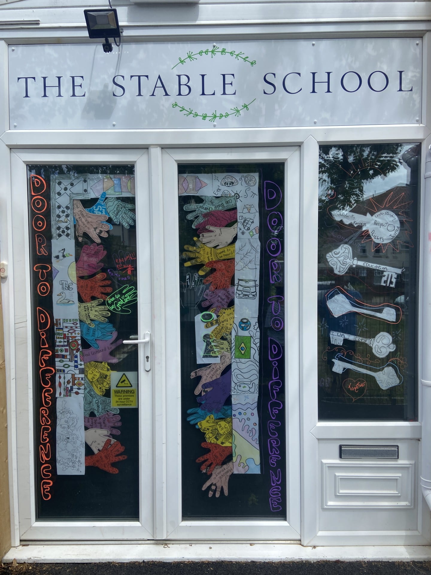 Colourful handprints, decorated keys and positive messages come together to showcase inclusion and belonging at The Stable School's EDI installation.